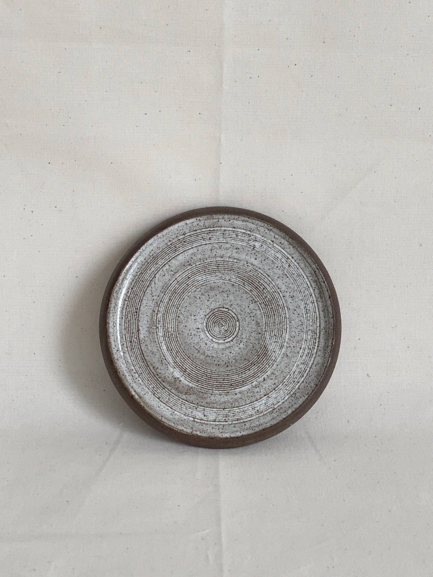 Wabi-sabi footed snow speckled plate